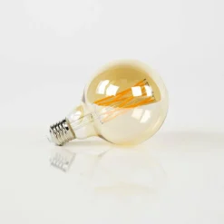 WoonStijl Lichtbron LED filament bol Ø9 5 - E27 6W dimbaar / Amberkleurig glas